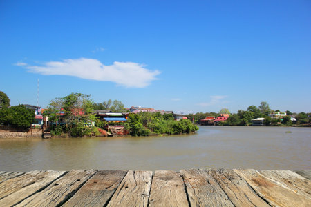 Wooden floor on the river with blue sky background, wooden table,Thailand.の写真素材