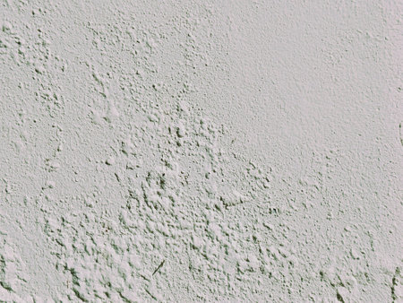 Texture, wall, it can be used as a background. Wall fragment with scratches and cracks, the paint appears bubbled or blistered due to trapped humidity within the concrete wallの写真素材