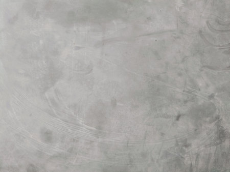 A vintage gray concrete wall with grunge texture and paper-like patternsの写真素材