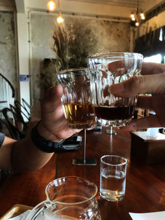 cheers!, Coffee party on the vintage cafe, meeting on coffee time, coffee and tea in hand cheers.の写真素材