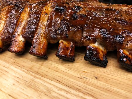 Pork Spare Ribs Barbecue on wooden plate, Top view and copy space for Advertisement. Dinner with barbecue at restaurant.の写真素材