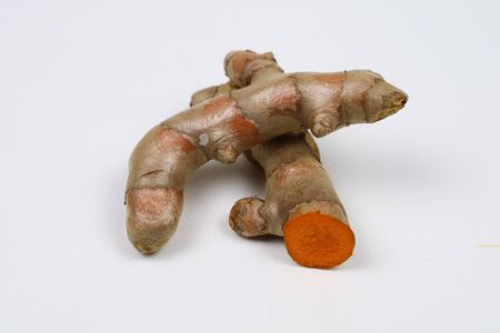 fresh turmeric roots isolated on a white background are ingredients in turmeric foods and ingredients in skin care products. Turmeric helps the skin to be strong.の写真素材