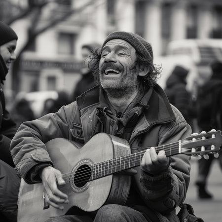 Black and white image of a joyful street musician playing guitarの素材