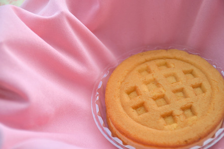 Shot of waffle in plastic cup on pink fabricの写真素材