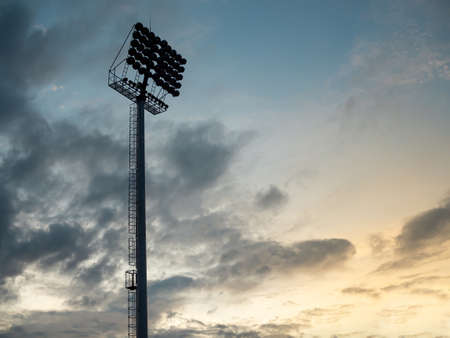 A spotlight pole in Football field on twilight skyの写真素材