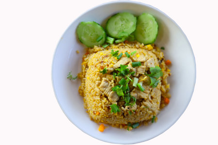 Fried rice with pork and vegetables in white bowl on white backgroundの写真素材