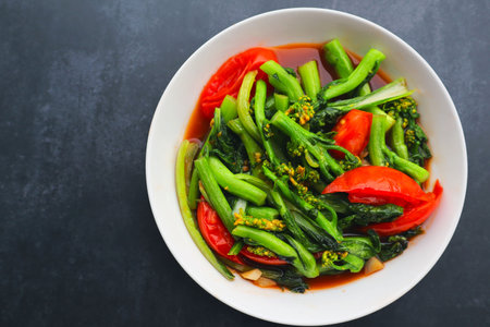 Top view of Stir fried vegetables with soy sauce on black background.の写真素材