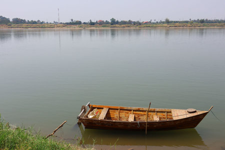 Wooden fishing boat on the bank of the Mekong River in Laos.の写真素材