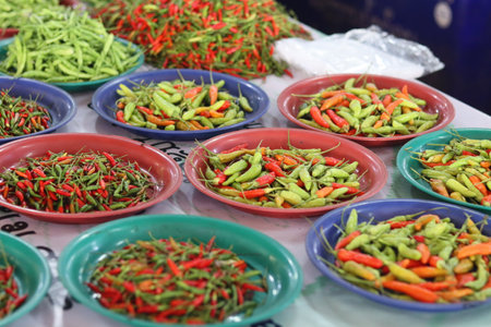Red and green chilli for sale at the local market.の写真素材