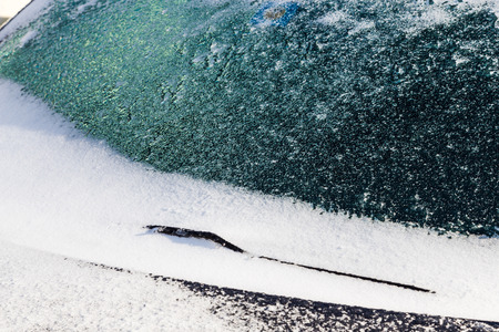 Ice and snow covers windshield and Windscreen wiper after snow stormの写真素材