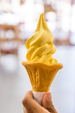 Mango soft cream in waffle cone.の写真素材