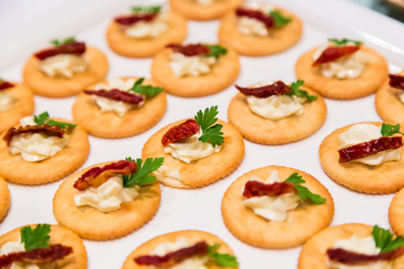 Cheese canape with chili on crackers in wedding partyの写真素材