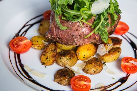 Grilled steak with fresh tomatoes and garlicsの写真素材