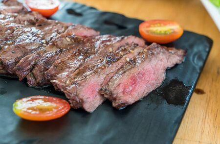 Delicious medium rare wagyu steak with fresh tomatoの写真素材