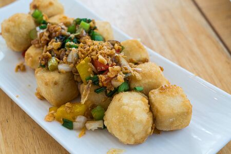 Deep fried tufu with garlic and bell peper sauceの写真素材