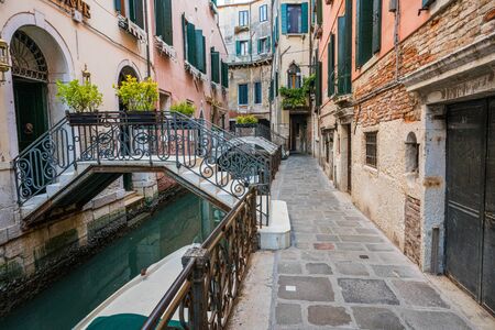 Street and canal in Venice, Italy.の写真素材