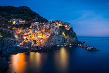 Colorful Manarola village in Cinque terre, Italy at nightの写真素材