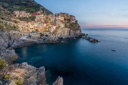 Colorful Manarola village in Cinque terre, Italy at sunsetの写真素材