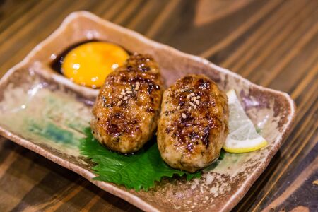 Traditional Japanese grilled chicken, Yakitori, with marinated egg yolkの写真素材