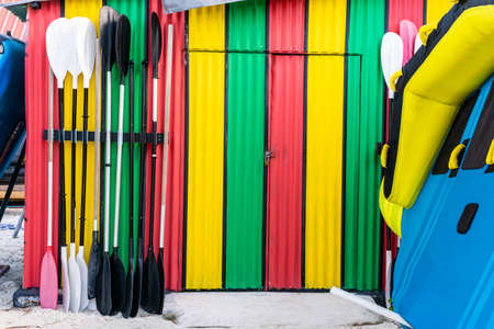 Colorful water sport storage with paddles in the front doorの写真素材