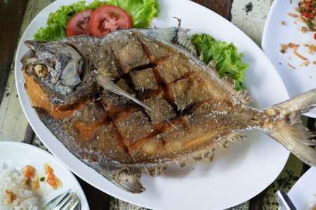 Deep fried Pompano with spicy sauce : Thai food.の写真素材