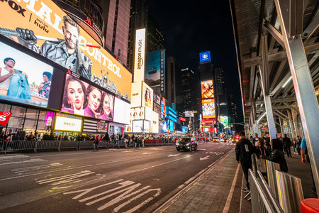 NEW YORK CITY, USA - April 11, 2023 : View of times square and broadway neon signs at night, it's...