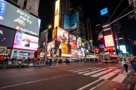 NEW YORK CITY, USA - April 11, 2023 : View of times square and broadway neon signs at night, it's...
