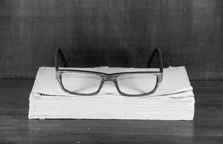 Glasses on old book background. Concept photoの写真素材