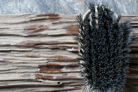 wire brush on wooden backgroundの写真素材