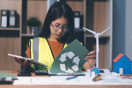 Female architect working at home She looked at the blueprint.の写真素材