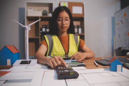 Female architect working at home She looked at the blueprint.の写真素材