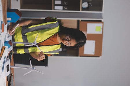 Female architect working at home She looked at the blueprint.の写真素材