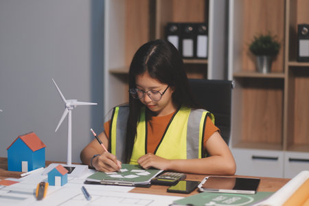 Female architect working at home She looked at the blueprint.の写真素材