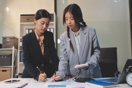teamwork of young business people with documents, laptop, and computer in office.の写真素材