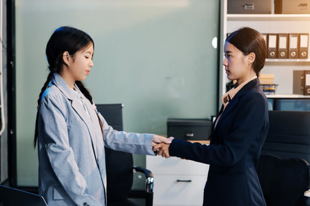 Business handshake for teamwork of business merger and acquisition,successful negotiate,hand shake,two businessman shake hand with partner to celebration partnership and business deal conceptの写真素材