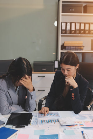 Asian women are stressed while working on laptop, Tired asian businesswoman with headache at office,...