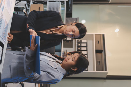 teamwork of tired young business with documents tax laptop computer in office.の写真素材