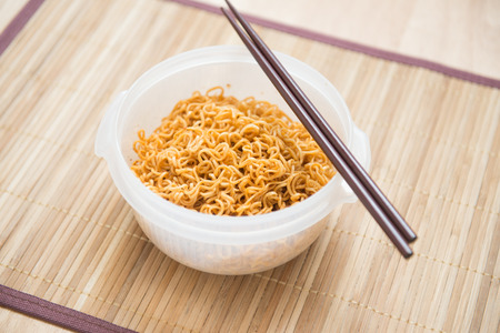 Ready noodle and chopsicks on tableの写真素材
