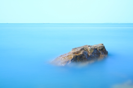 Stone in blue sea   Long exposure shot の写真素材