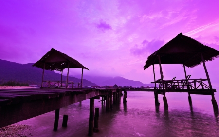 Early morning light with a wooden path of the hut at the beachの写真素材