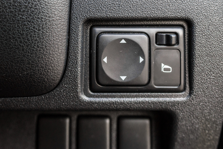 Button in car for adjust side mirror.