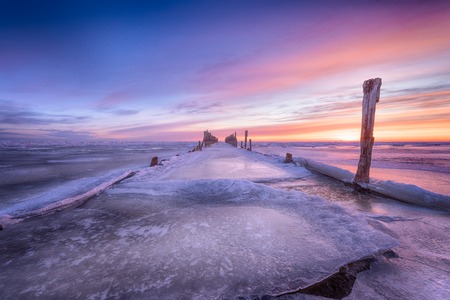 Winter seascape of wood breakwaters on frozen Baltic seaの写真素材