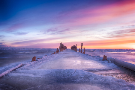 Winter seascape of wood breakwaters on frozen Baltic seaの写真素材