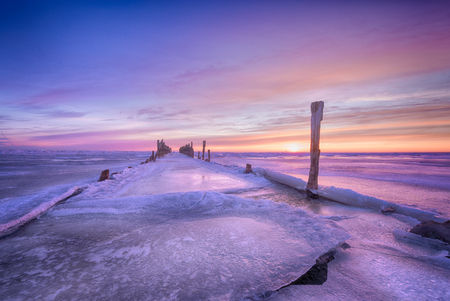 Winter seascape of wood breakwaters on frozen Baltic seaの写真素材