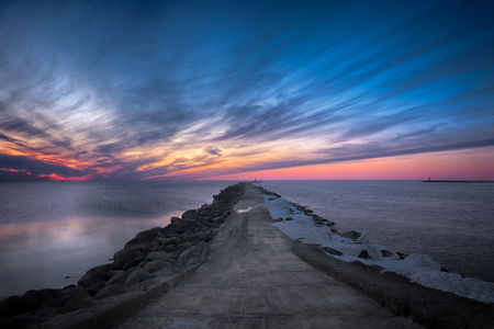Road to the lighthouse. Sunset at the Baltic seaの写真素材