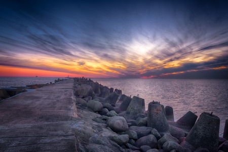 Road to the lighthouse. Sunset at the Baltic seaの写真素材