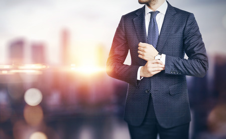 Businessman on blurred city background