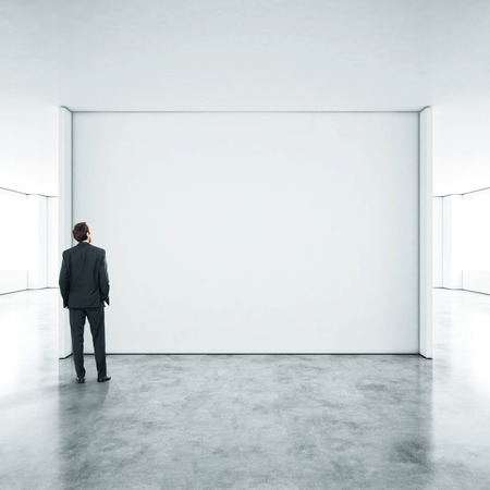Businessman standing in empty officeの写真素材