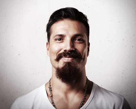 Brutal bearded hipster guy is smilingの写真素材