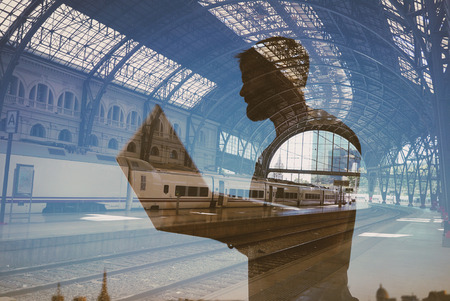 Double exposure of man with laptop on the stationの写真素材